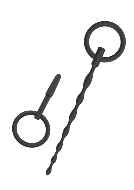 Black silicone set of two penis plugs with ring handles, one twisted and one straight, isolated on white