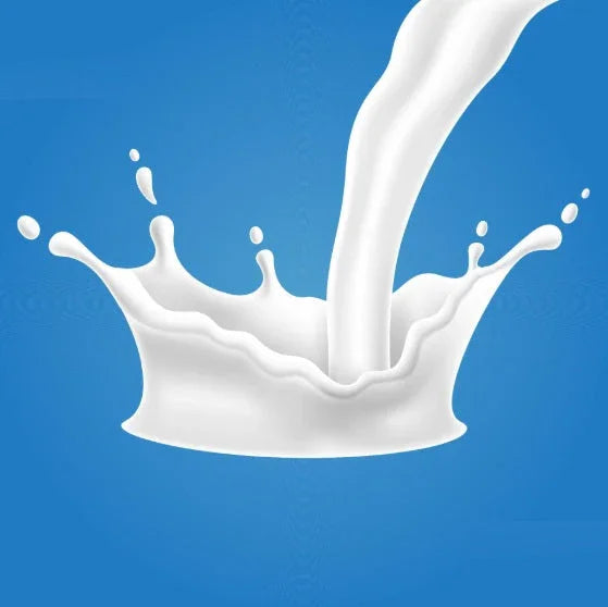 White liquid splash detailed against blue background, representing dynamic milk pour