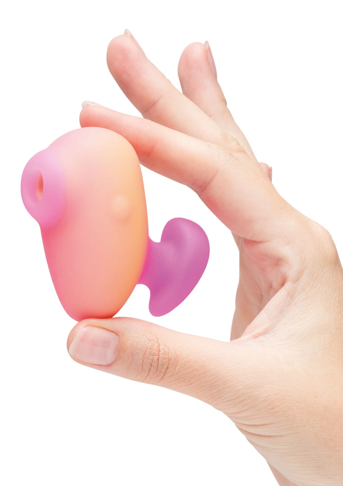 Roze vibrator vastgehouden in hand met paars hartvormig hulpstuk en ronde opening