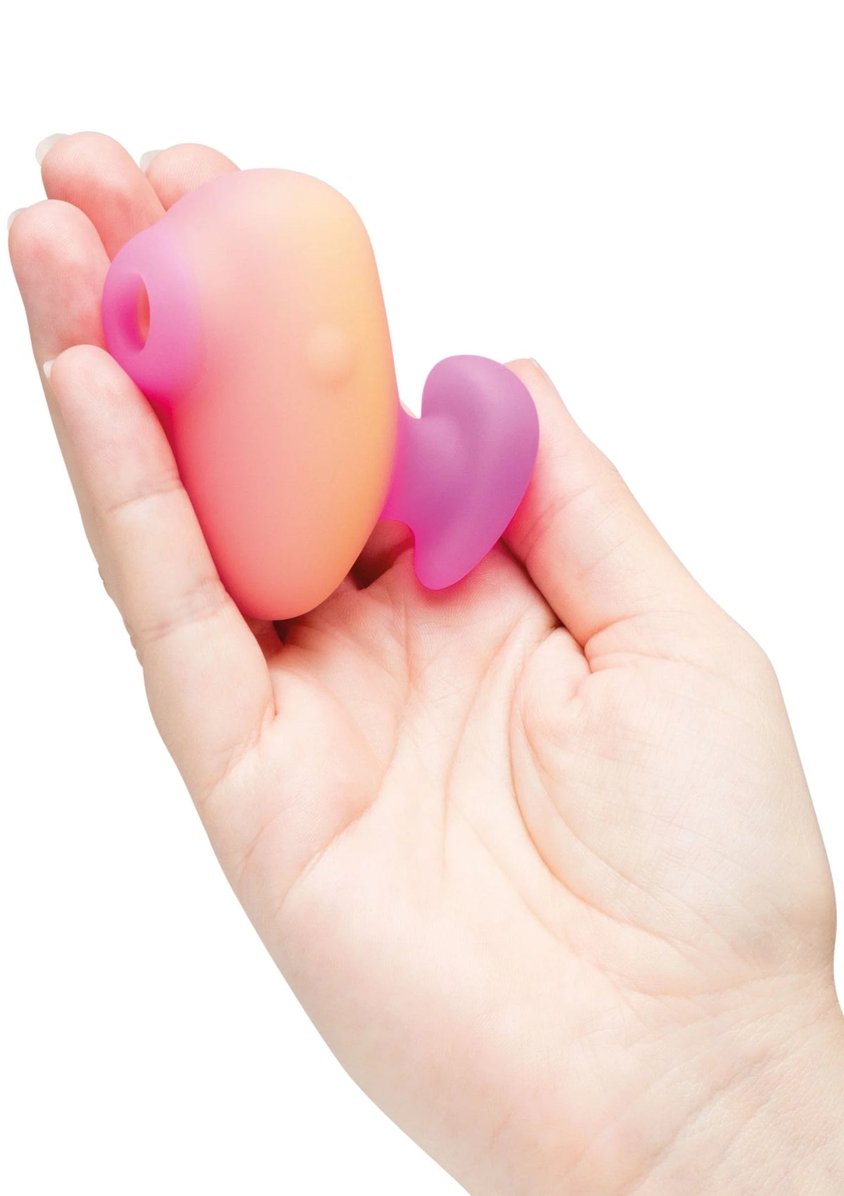 Ovale roze vibrator met paars hartvormig hulpstuk, in open hand gehouden