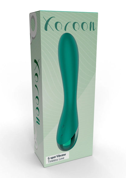 Groene Xocoon G-spot vibrator met gebogen vorm, staand op de verpakking
