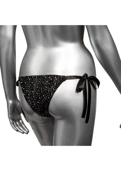 Zwarte stringpanty met glinsterende stippen en lange zijstrikbanden, close-up