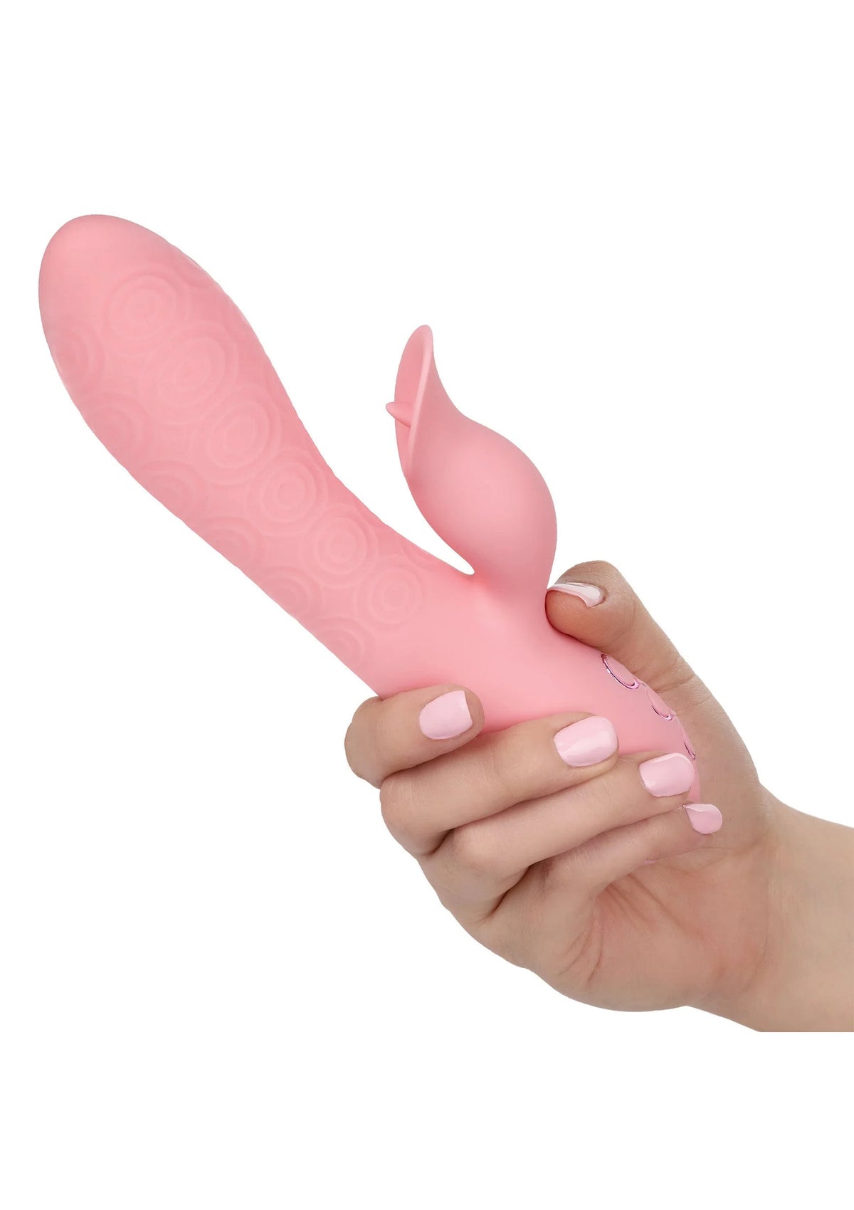 Roze vibrator in hand met getextureerd oppervlak; kleine uitstulping en ovale basis zichtbaar.