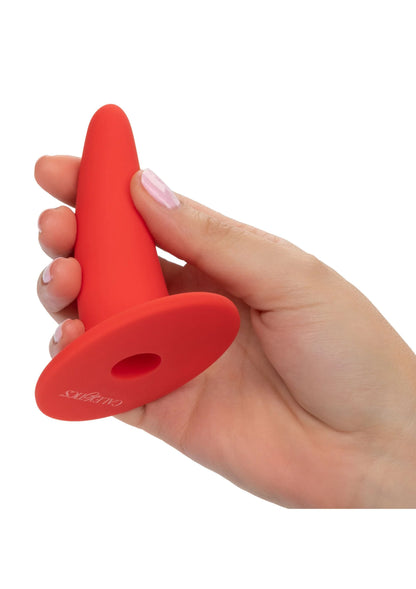 Rode vaginale dilatator vastgehouden in de hand, met ronde schijf en ovale opening