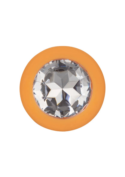 Oranje anale plug met grote kristal-inzet in ronde flens en gladde steel.