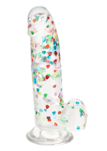 Hart-gevulde dildo met transparante schacht, kleurrijke hartjes en zuignapvoet; schuin beeld