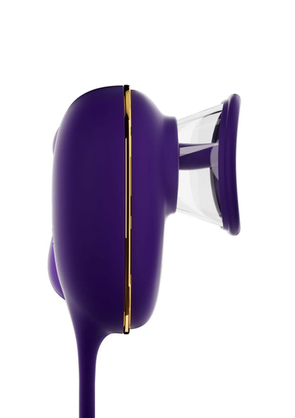 Zijkantweergave van paarse automatische stimulator met transparante zuignap en gouden rand