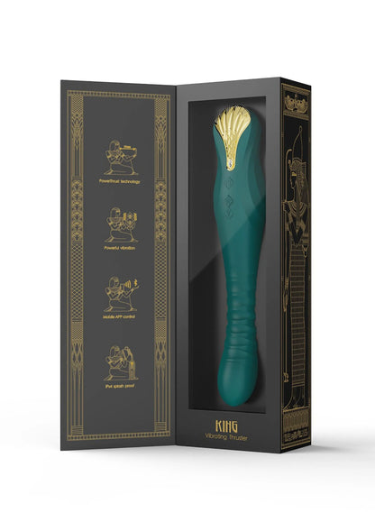 Doosverpakking met groene dildo en gouden ornamentillustraties.