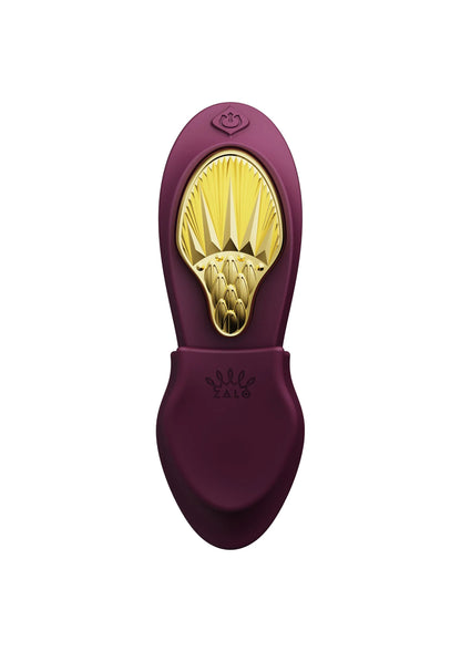 Draagbare vibrator Zalo bordeauxrood, open uiteinde met gele gouden binnenkant.