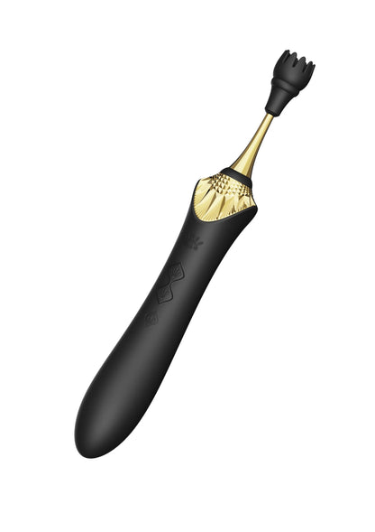 Clitorisvibrator in zwart met gouden top en knopjes, gebogen ontwerp.