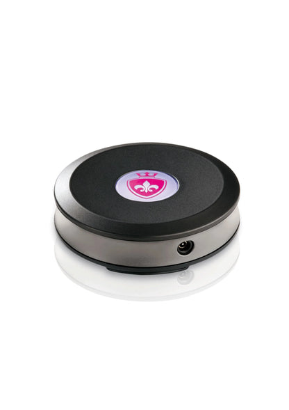Ronde elektrostimulatie-schijf met roze centraal pictogram, zwart oppervlak en zilveren rand