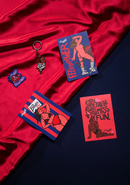 Sleutelhanger en reclamekaartjes met stripfiguur op rood en donker satijn