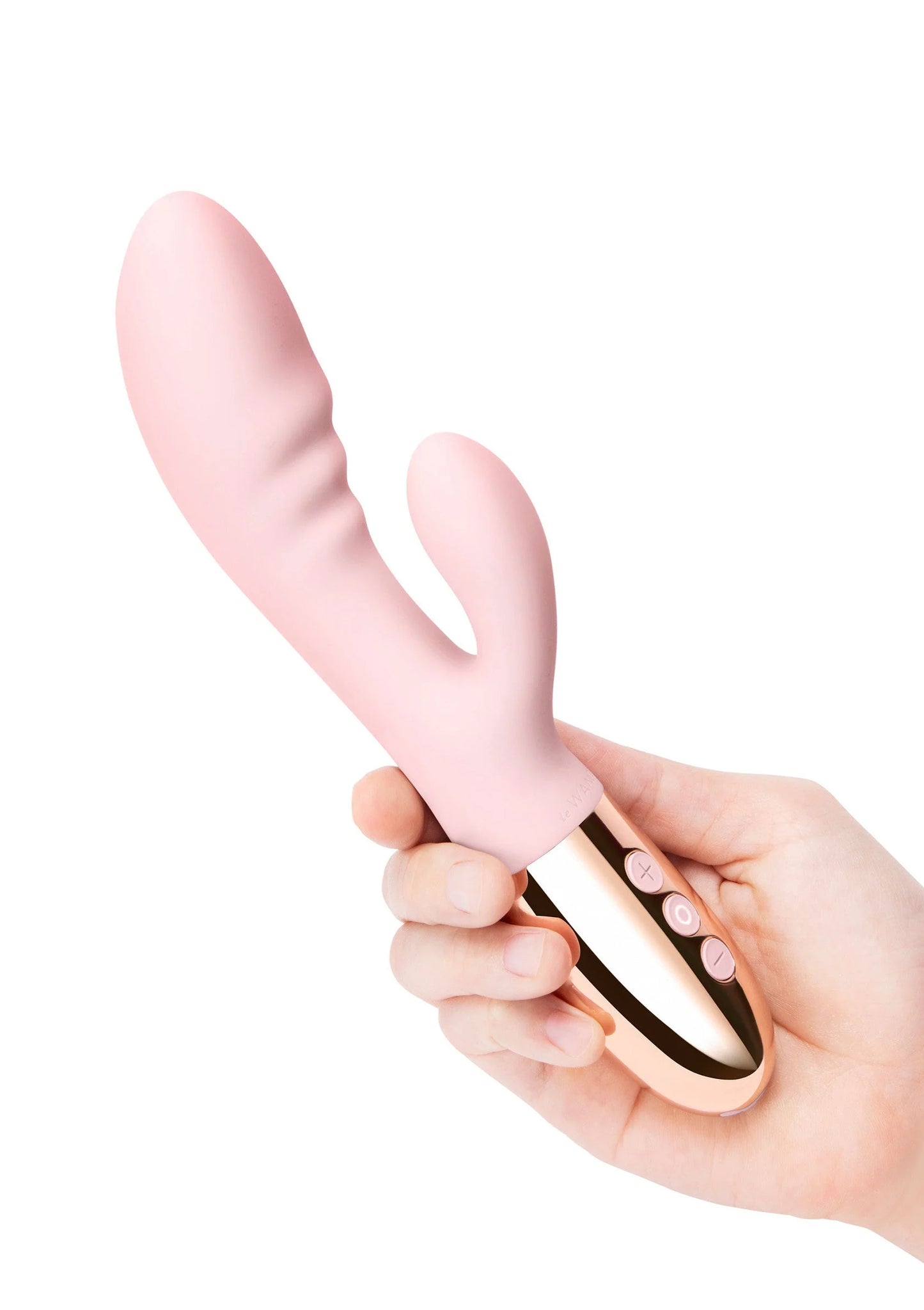 Roze Le Wand Blend duo-vibrator in hand, met knoppen op de roségoudkleurige basis