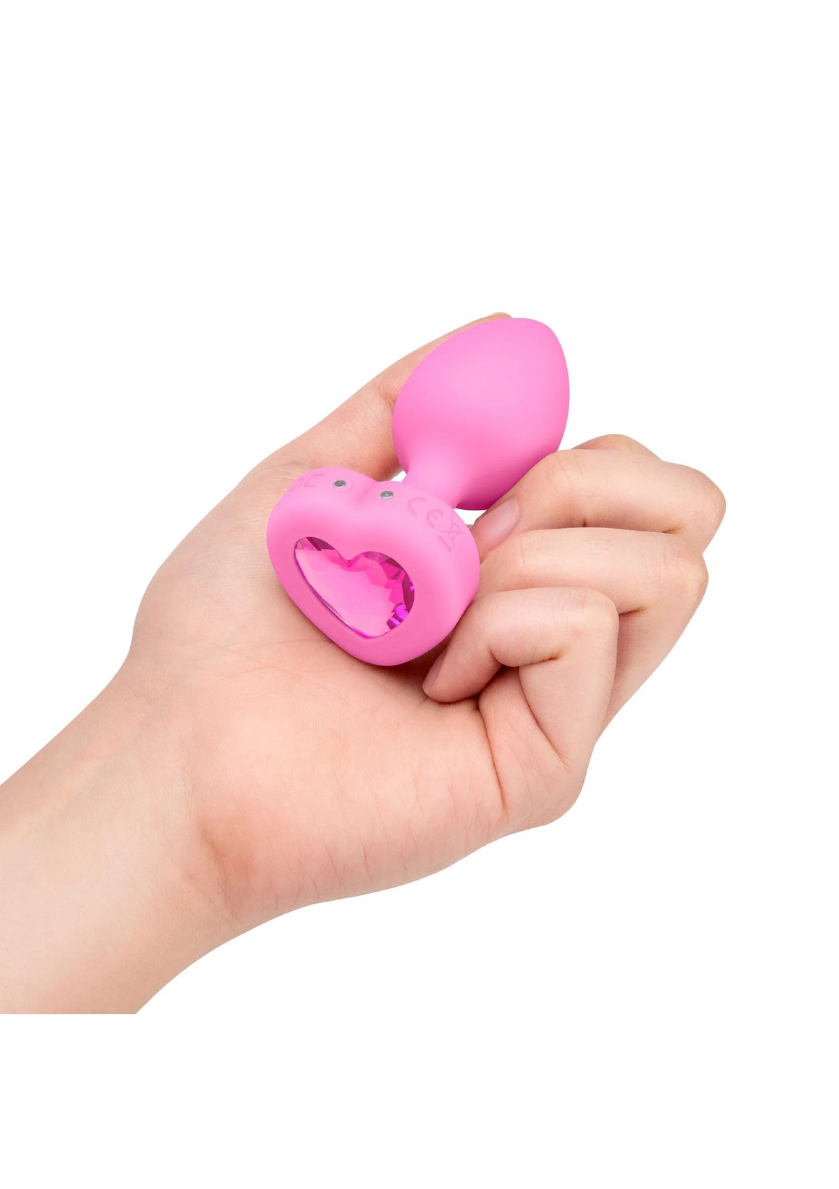 Roze B-Vibe hartvormige anale plug met glanzend hart in hand
