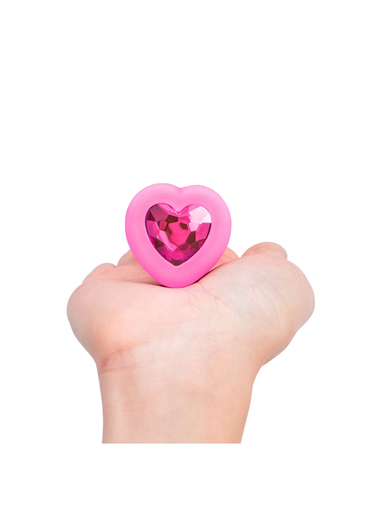Roze hartvormige anale plug met glanzende hartinzet in hand
