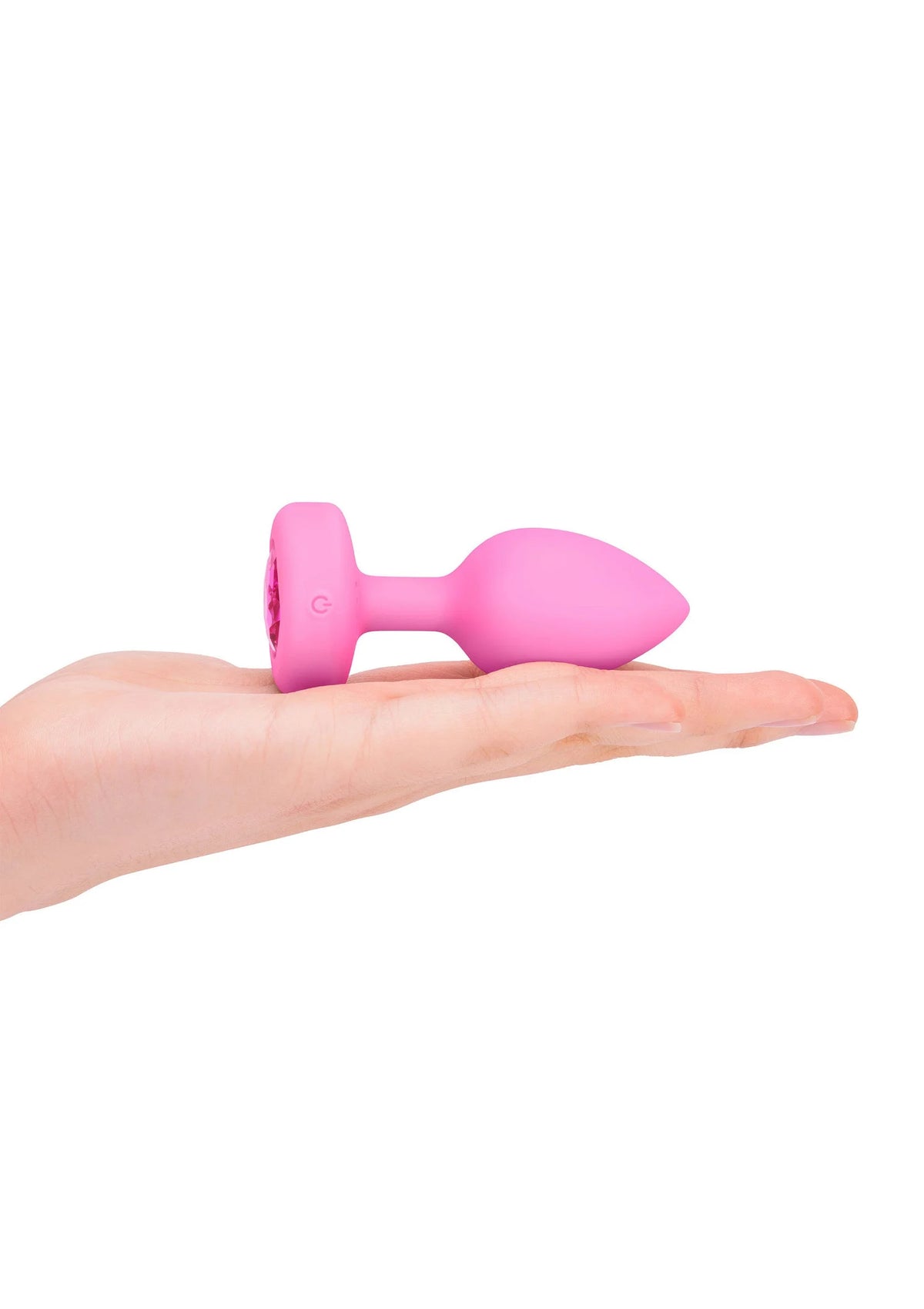 Roze hartvormige anale plug met ronde basis, liggend op hand