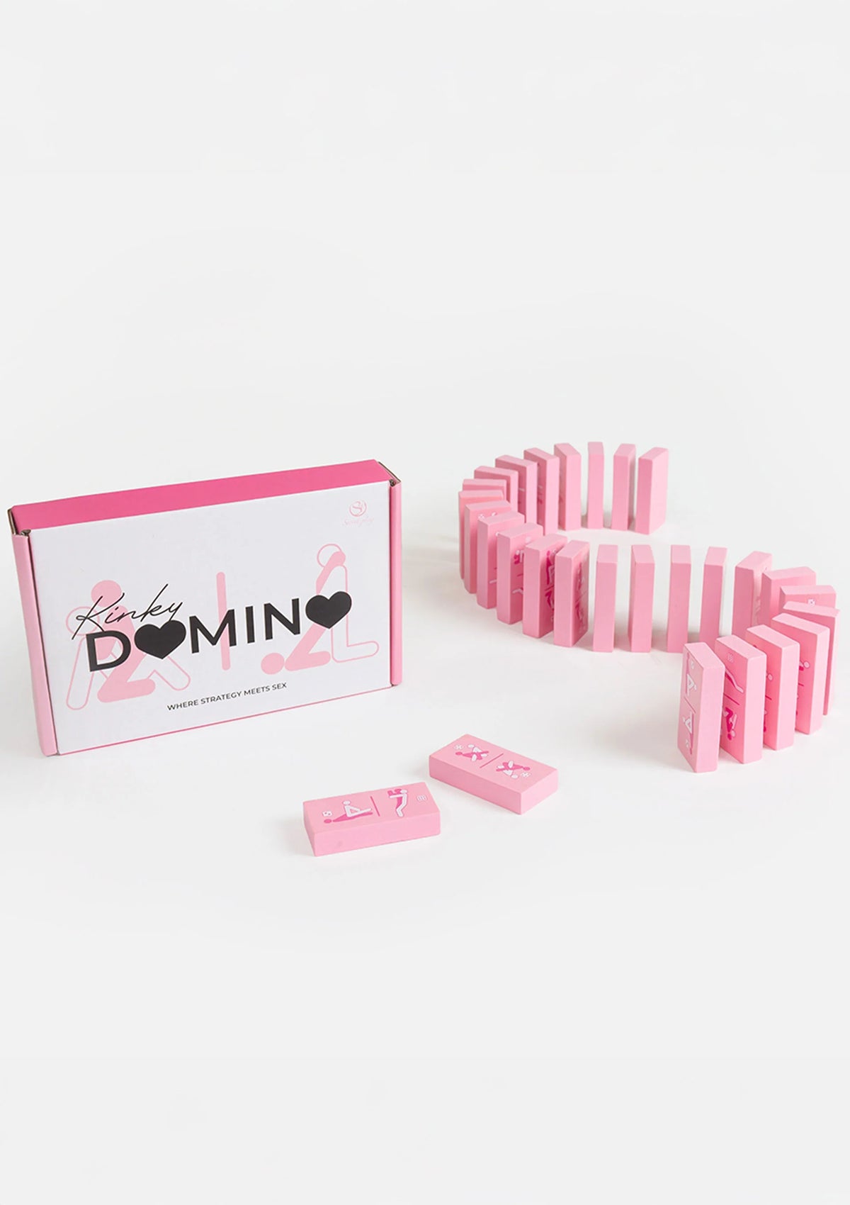 Kinky Domino doos naast roze domino-rij en een paar losse domino’s