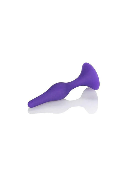 Purple silicone butt plug with flared base on white background for intimate use