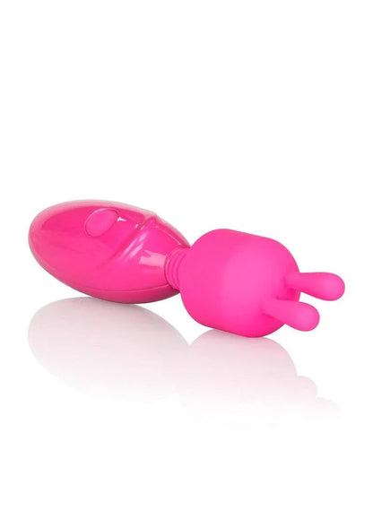 Bright pink handheld personal massager with dual prongs on a reflective white surface