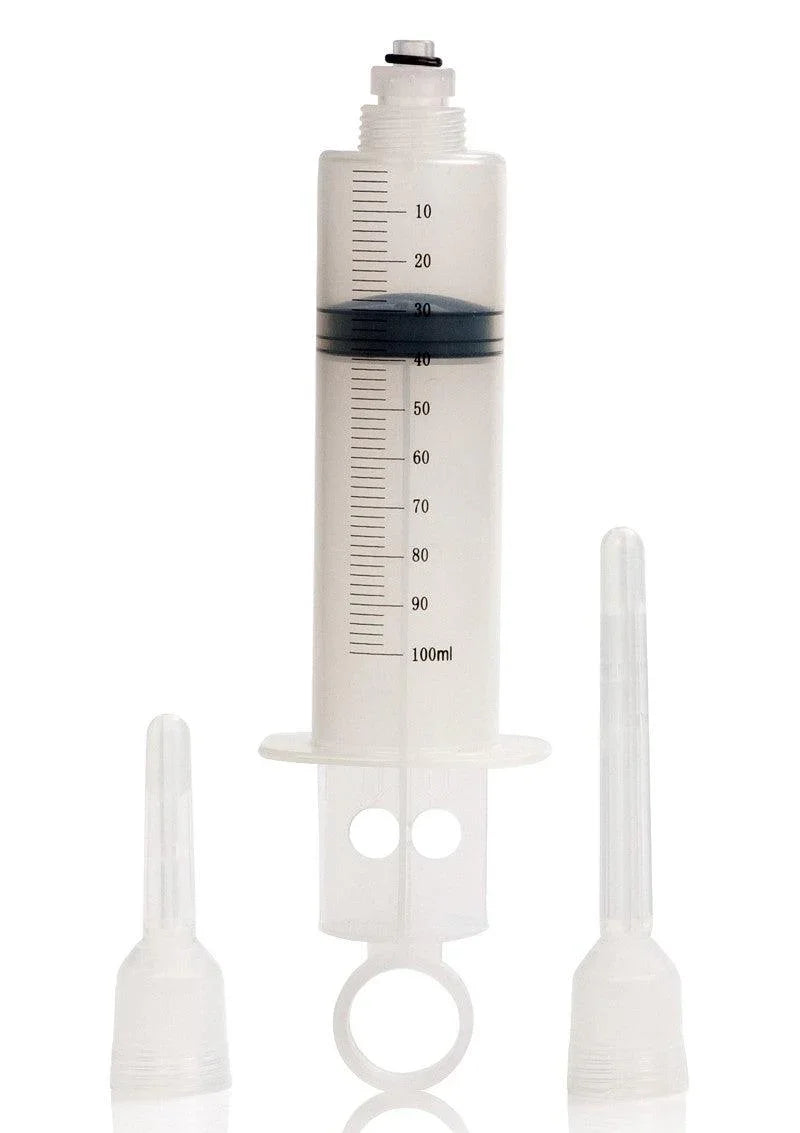 Universal clear plastic 100ml syringe with two interchangeable transparent nozzles on white background