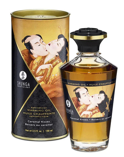 Verwarmende olie Caramel Kisses (100 ml) van Shunga, met fles en verpakking.