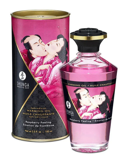 Shunga verwarmende olie fles met roze inhoud en zwarte dop; framboos 100 ml